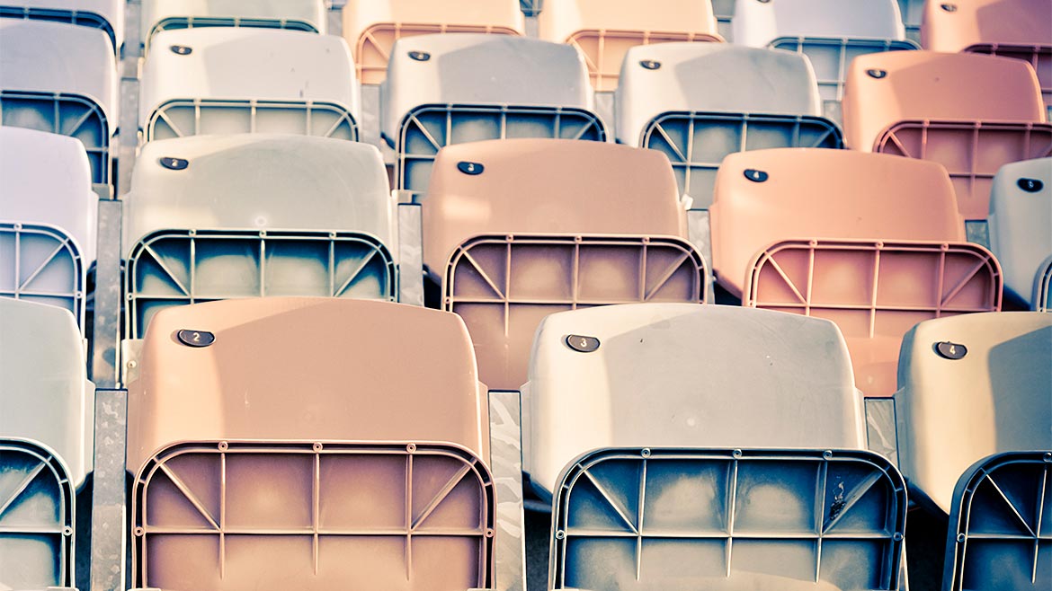 Accelerated Weathering Testing features: row of faded stadium seats