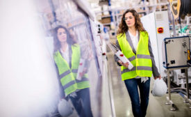 woman in reflective vest carrying binder